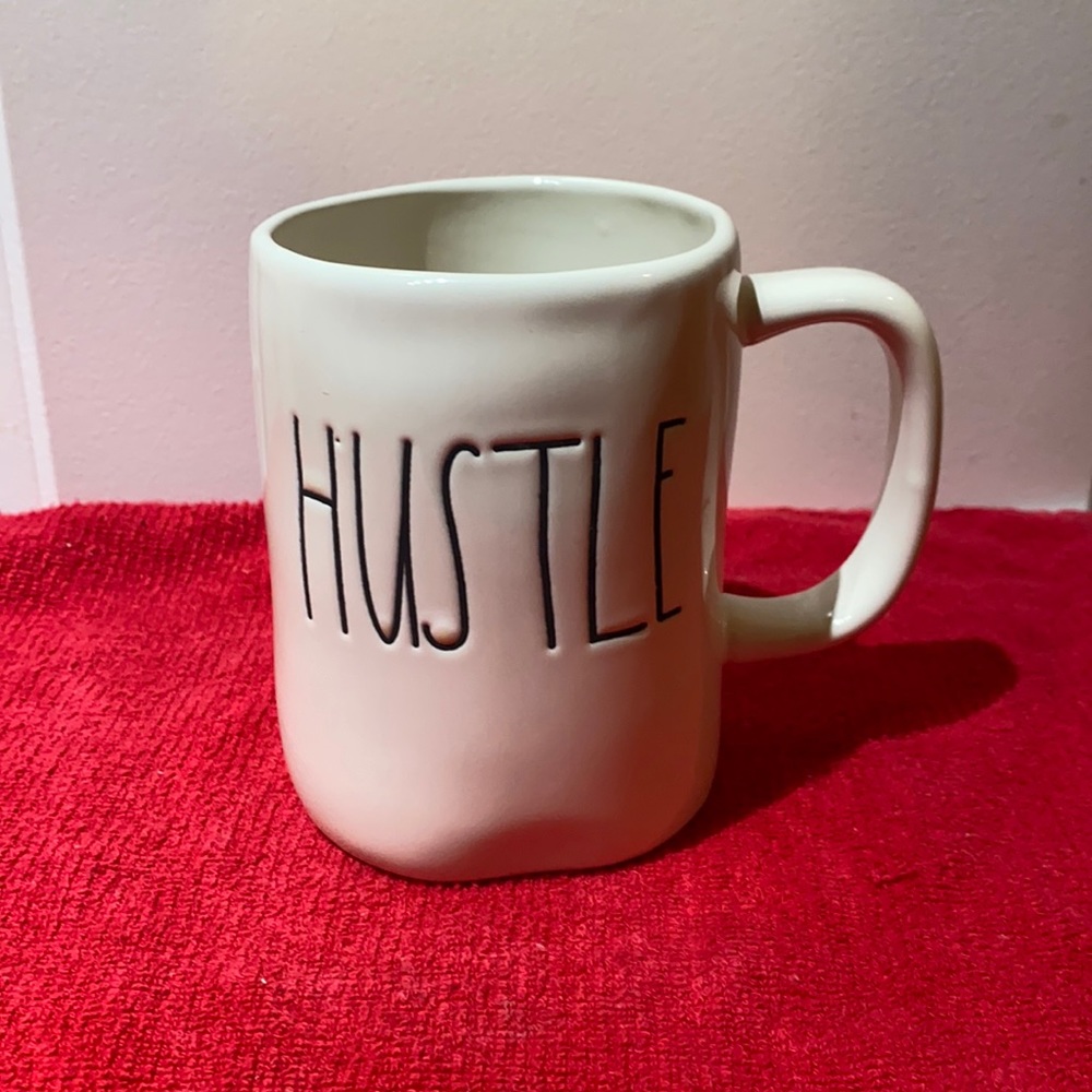 Rae Dunn mug with “Hustle” text